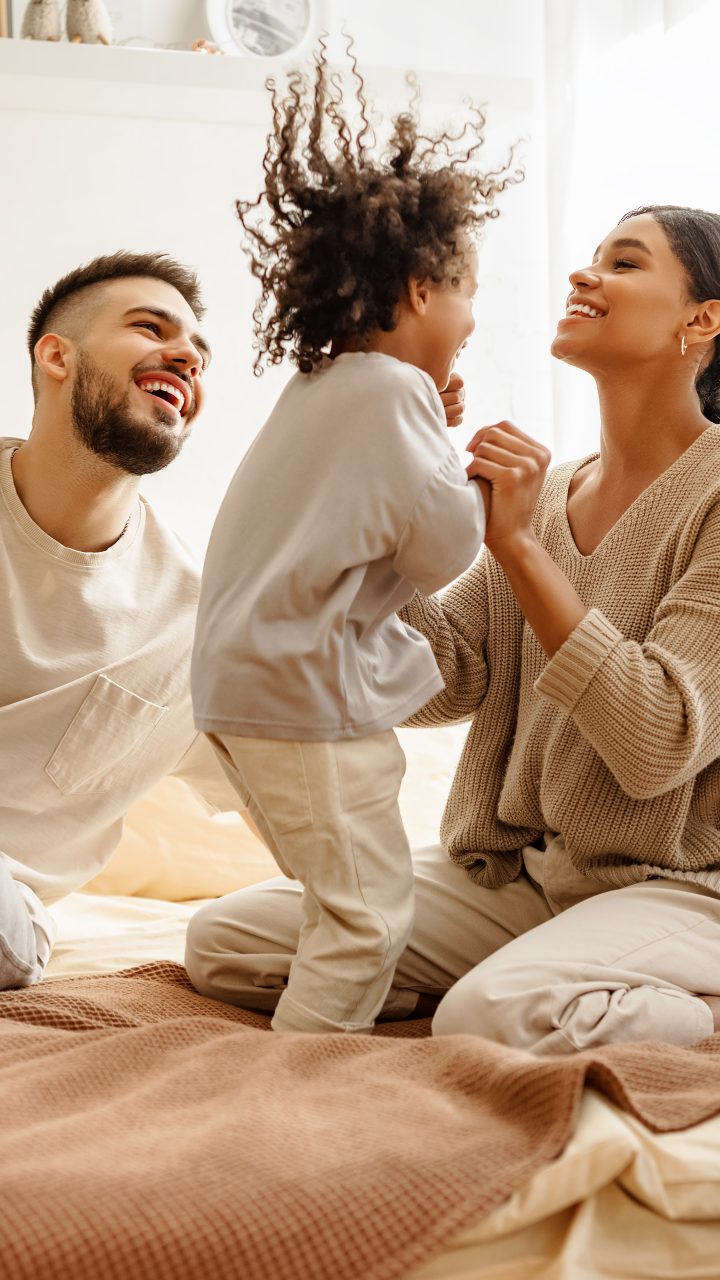 a family is sitting on a bed together at The Soltera Rolling Pines