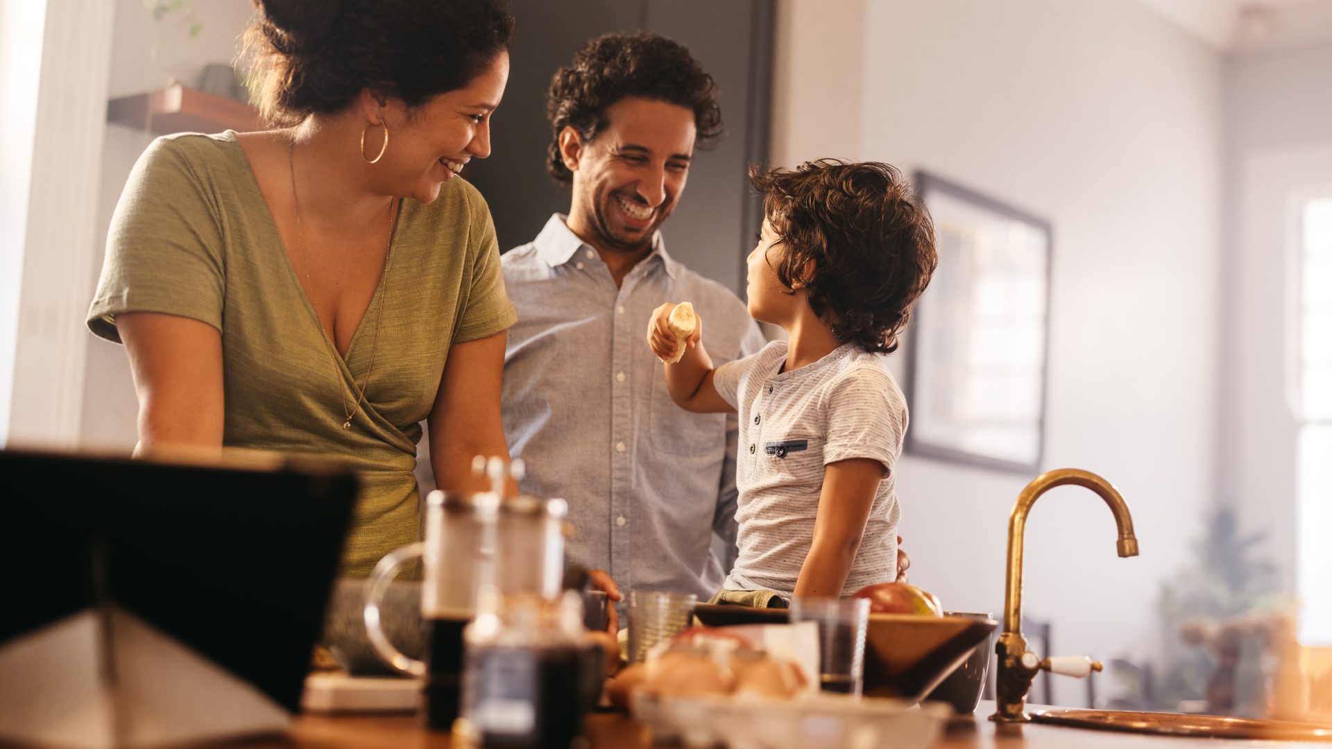 a family is standing in the kitchen with a child at The Soltera Rolling Pines